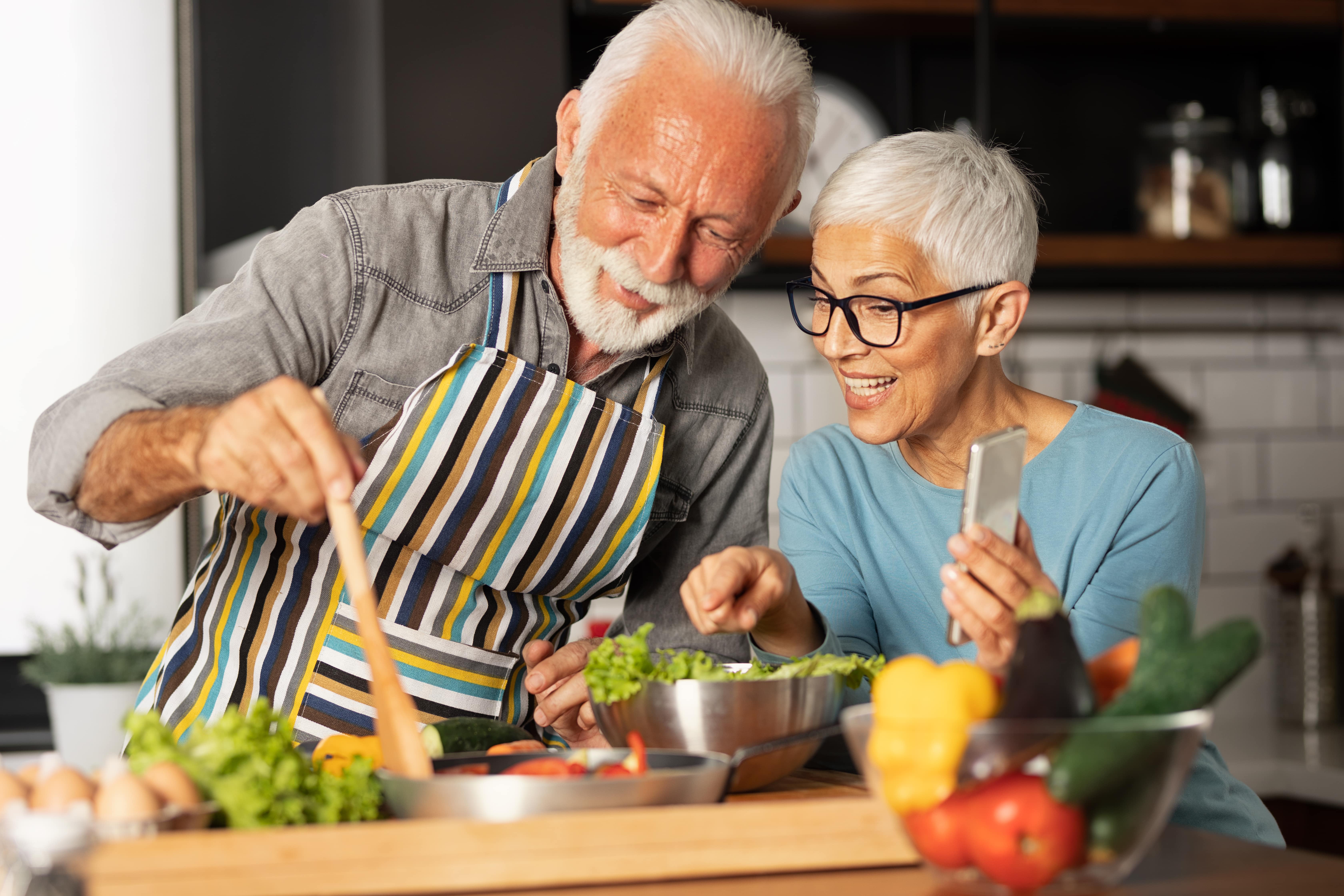 Senior white couple making healthy food